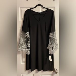 Black dress with mesh sleeves and embroidery